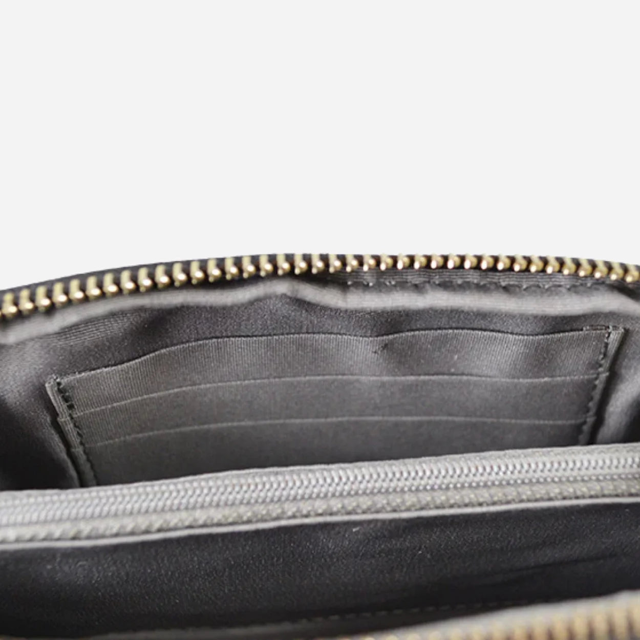 Burgundy zippered pouch with black interior lining on a light gray background