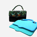 Black handbag with green leaf pattern and blue pouches on a white background