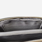 Burgundy zippered pouch with black interior lining on a light gray background